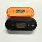 Load image into Gallery viewer, Two digital devices, one orange and one black, on a white background